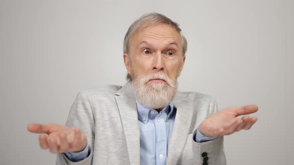 Upset Man Looking to Camera in Studio