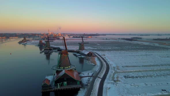 Wooden Wind Mill at the Zaanse Schans Windmill Village During Winter with Snowy Landscape Snow