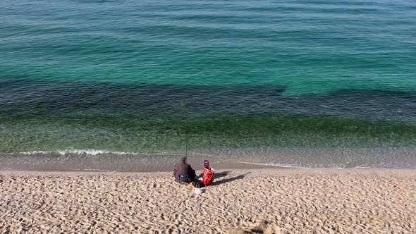 Fishermen fish on the beach Aerial view 4 K