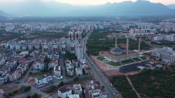 Modern City Panorama with View of Mosque Minaret and Mountains