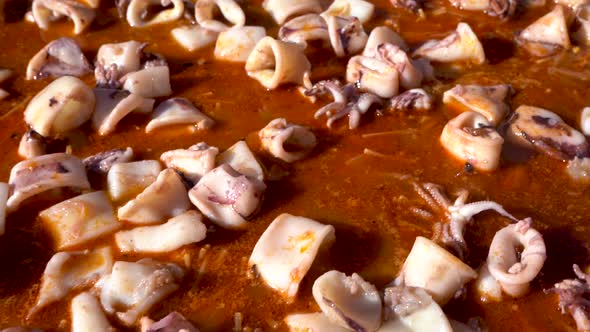 Squid cooked in sauce to prepare paella