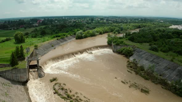 Aerial Drone View. River Water Move Down From with a Water Filled Dam After Heavy Floods and Rains