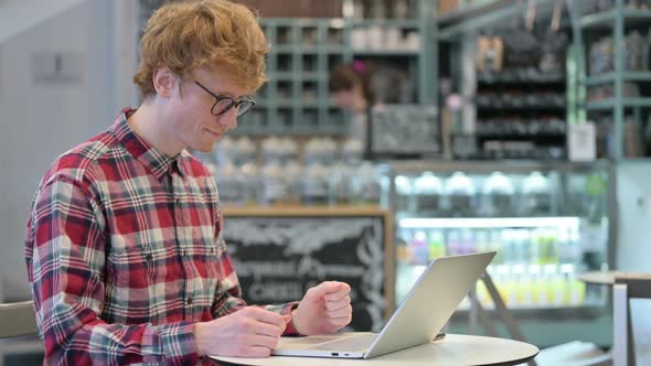 Online Video Chat on Laptop By Young Redhead Man