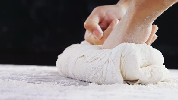 Woman kneading a dough