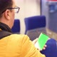 Blank Digital Phone in Hand of Guy Standing Indoors in Public Transport - VideoHive Item for Sale