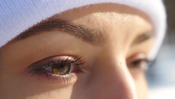 Detail View of Woman Brown Eyes Looking Around. Attractive Girl Standing in Winter Forest and