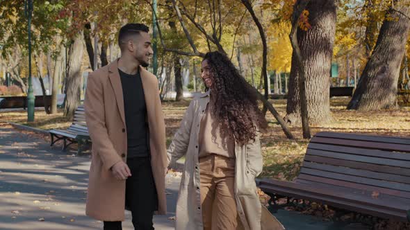 Young Positive Arabic Couple Walking Holding Hands Date in Autumn City Park Attractive Girl Happily