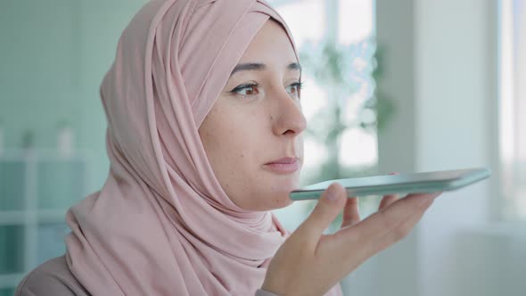 Arabian Woman Islamic Businesswoman Recording Voice Recognition Message on Speakerphone Using Audio