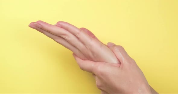 Close up of rubbing female hands applying cream.