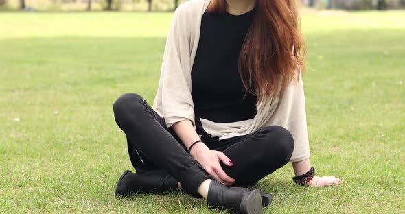 Happy young woman relaxing at park