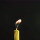 Single Big Yellow Candle Flame Lights and Extinguish Isolated on a Black Background Slow Motion - VideoHive Item for Sale