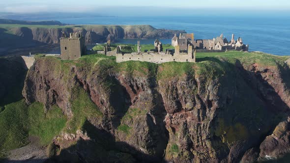 beautiful scenic flight level with the ruins of the once mighty  dunnottar castle in scotland shows