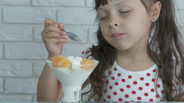 The kid eats ice cream. 