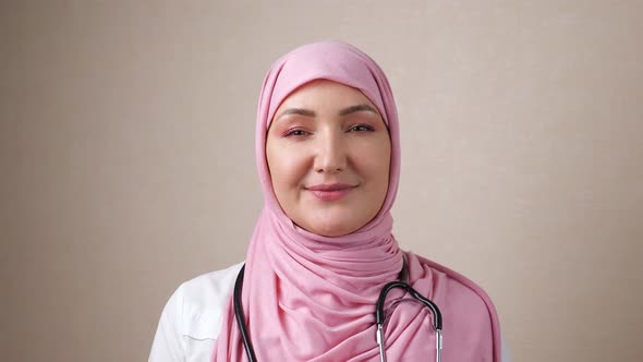 Woman Doctor in Hijab with Phonendoscope on Neck Smiling Looking at Camera