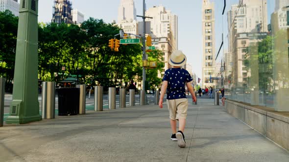 Boy In Hat Walking Through New York City Streets