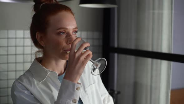 Closeup Face of Happy Young Woman Drinking White Wine From Wineglass at Home Slow Motion