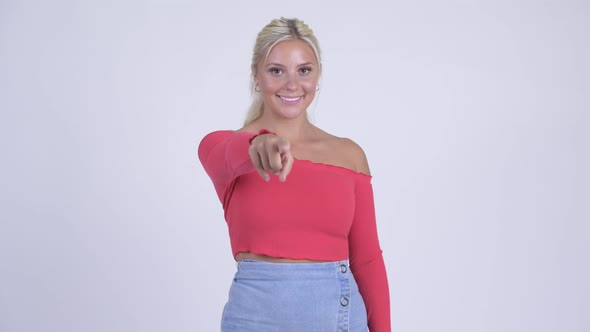 Happy Young Beautiful Blonde Woman Pointing at Camera