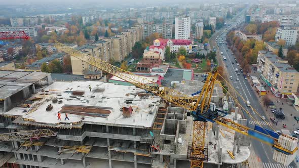 Crane and building equipment. Construction progress of new modern skyscraper in city