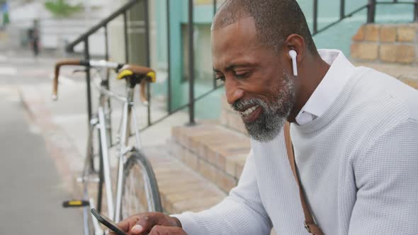 African American man using his phone in the street