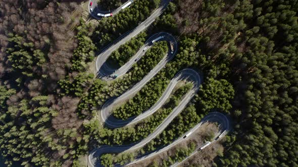 Fast counterclockwise aerial rotate of traffic on Bratocea Pass, Romania