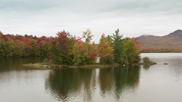 Cinematic Aerial Island in Mountain Lake Vermont Peak Season Foliage Background