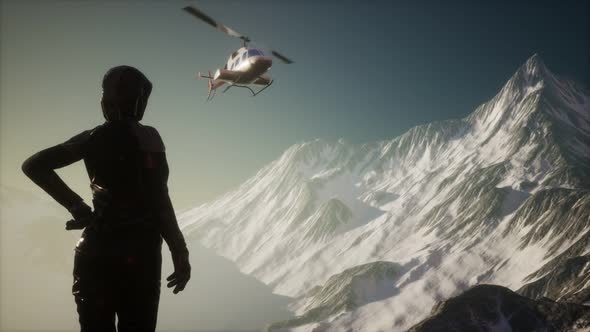 Woman and Helicopter in Winter Mountains