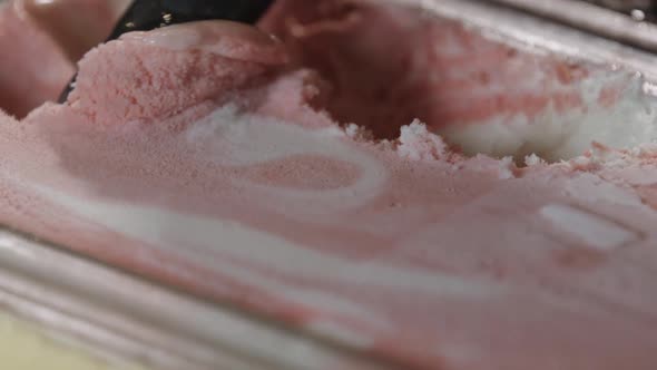 Scooping Strawberry Ice Cream to Cone