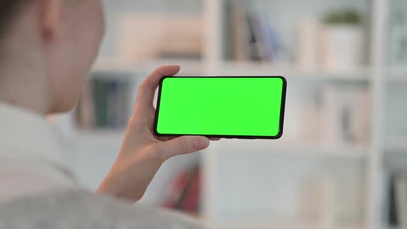 Rear View of Woman Doing Online Meeting on Smartphone with Chroma Key Screen