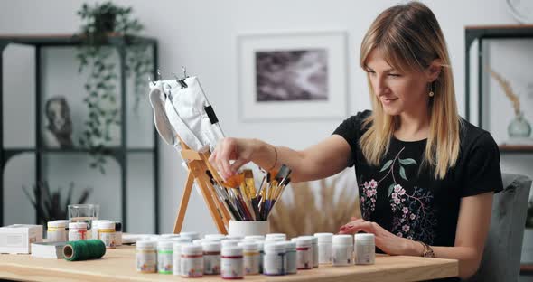 Female Artist Preparing Workplace for Drawing