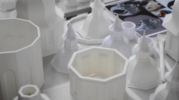 Many White Objects Printed on 3d Printer Lie on Flat Surface