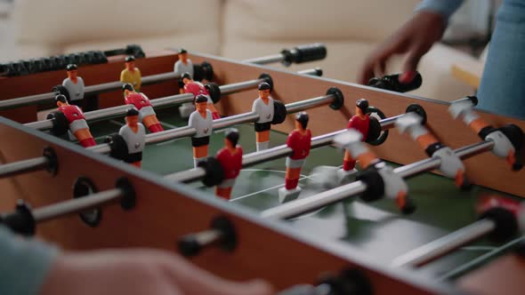 Close Up of Coworkers Using Foosball Game Table for Fun