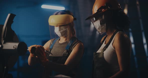 Factory Female Workers Measuring Diameters of Pipe Piece