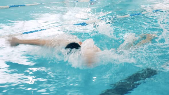 Swimmer Practicing Butterfly Technique in a Pool