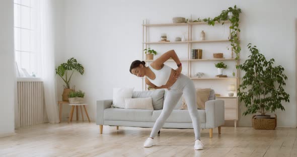 Intensive Workout at Home. Young Sporty Black Lady Twisting Her Body at Living Room, Slow Motion