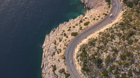 Cars Driving By the Highway Near the Turquoise Sea