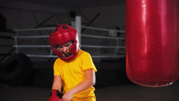 A Little Boy Doing Boxing  Takes Off the Protective Helmet