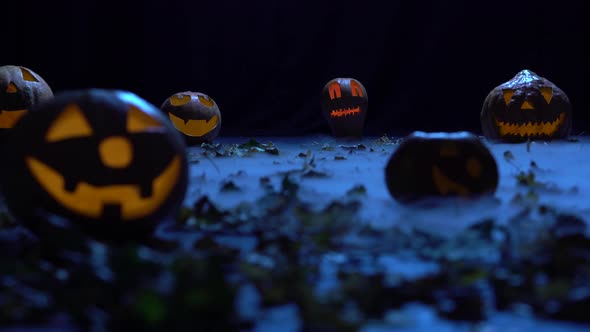 Scary Pumpkins on Halloween in the Dark Forest Are Burning Like Lanterns in Smoke