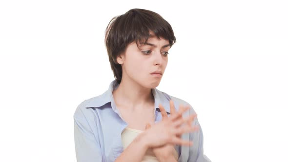 Nervous Caucasian Young Female Standing Over White Background at Loss