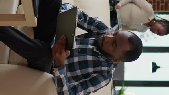 Vertical Video Portrait of Young Man Working with Information on Laptop