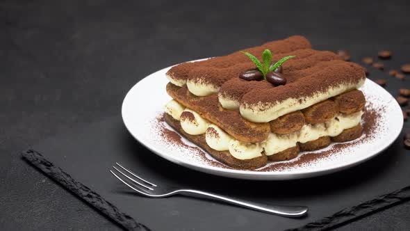 Classic Tiramisu Dessert on Ceramic Plate on Concrete Background