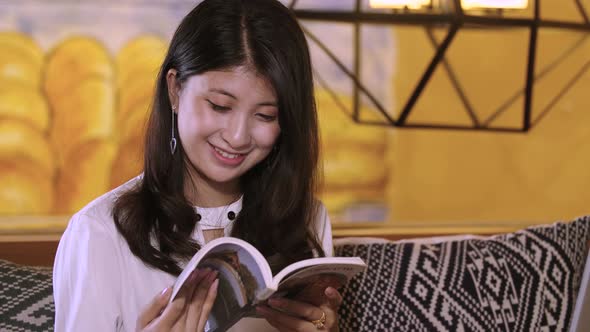 Beautiful Asian Girl Reading Book