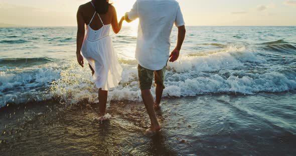 Happy Couple on the Beach at Sunset