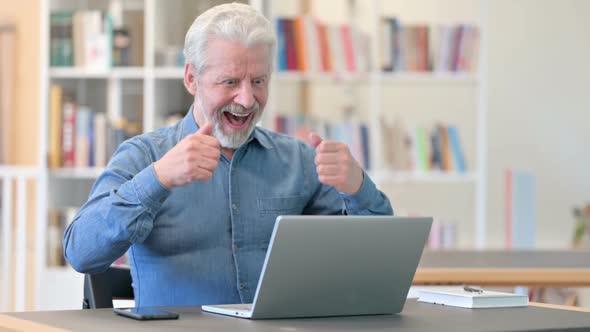 Old Man Celebrating Success on Laptop