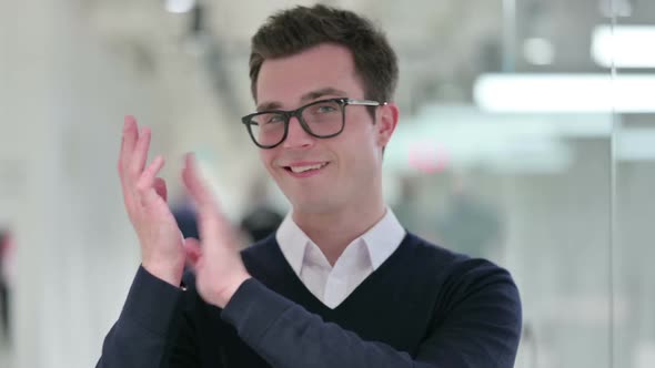 Excited Young Businessman Clapping Cheering