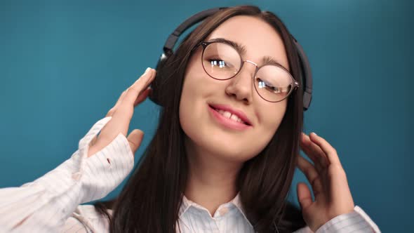 Closeup Face of Teen Woman Relaxing Listen Audio Wearing Earphones