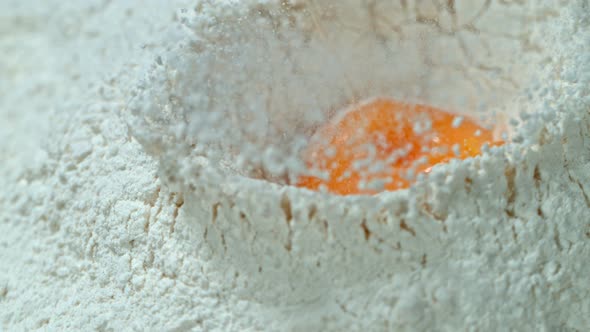 Super Slow Motion Shot of Falling Egg Into Flour at 1000Fps.