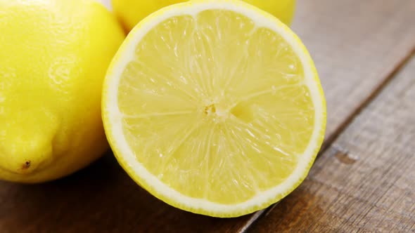 Full and half lemons on table