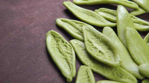 Foglie spinach green pasta on a wooden rustic surface. Dry Italian handmade macaroni. Macro