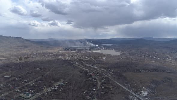 Aerial view of copper plant in city, low houses and Ural mountains 33