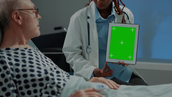 Surgeon Woman Holding Green Screen Tablet in Hospital Ward